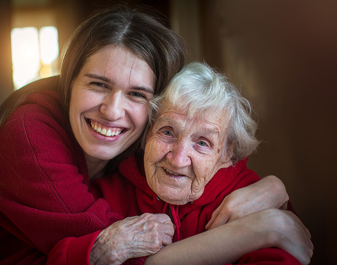Woman hugging elderly mother